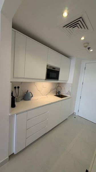 Studio kitchen after — new cabinets, splashback and clean lines