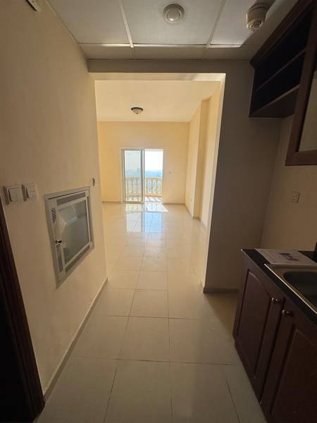 RAK studio apartment before Coenraad’s renovation — tired walls, dated fit‑out