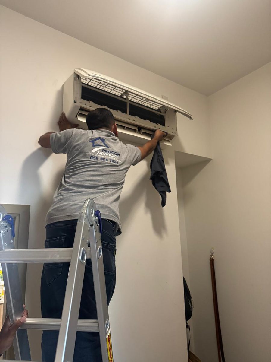Procon team member servicing a split AC unit