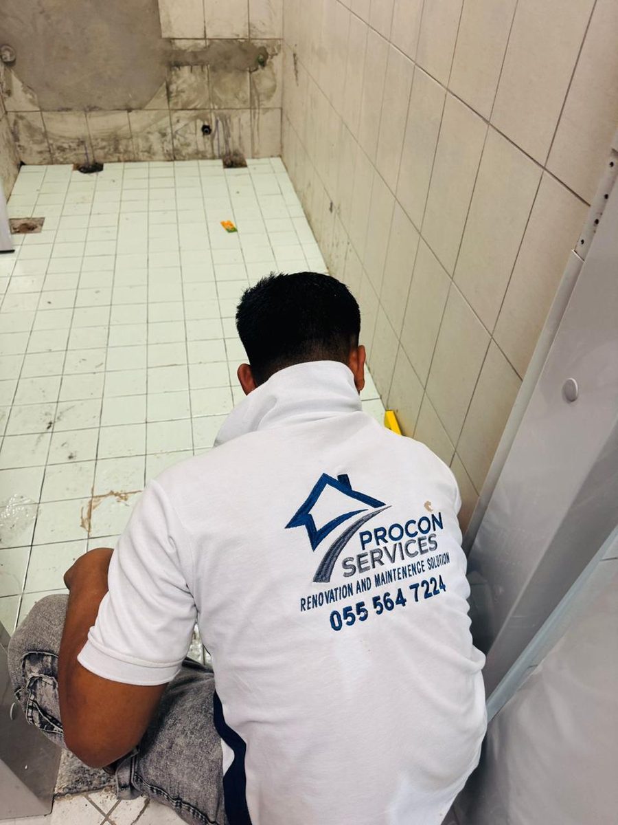 Procon team member prepping a bathroom floor for new tiles