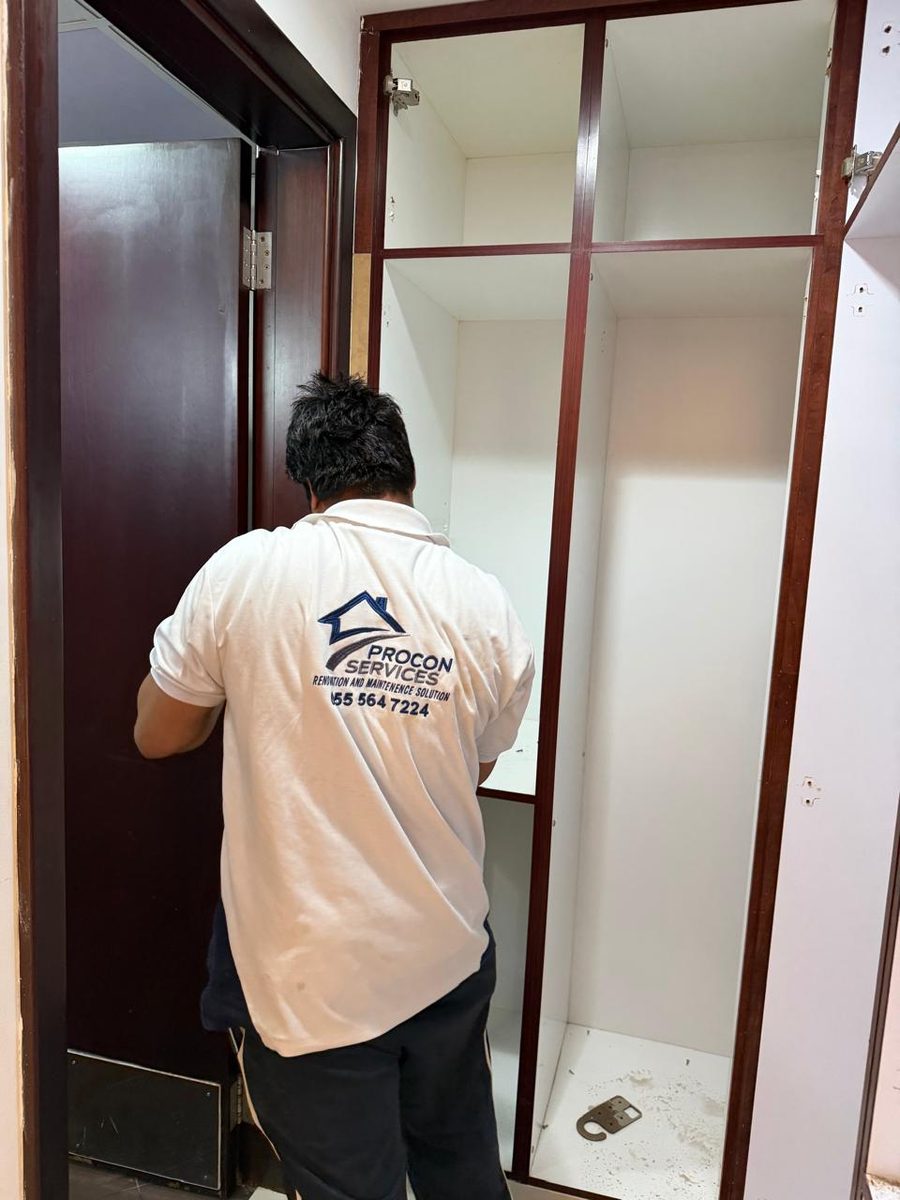 Procon team member fitting a built-in wardrobe in an RAK apartment